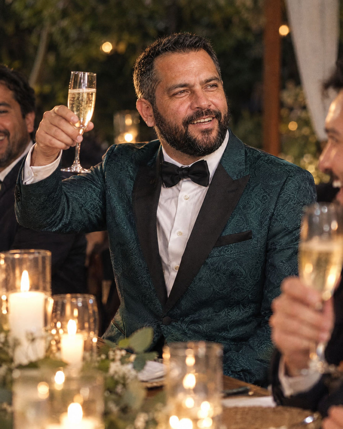 Invitado con esmoquin Imperiale Esmeralda brindando en una cena de matrimonio